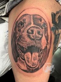 a tattoo of a dog on a woman's thigh