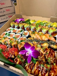 a box filled with sushi and a flower
