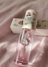 a pink bottle with a pink flower on it