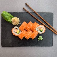 japanese sushi on a slate plate with chopsticks