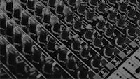 a black and white photo of a mixing board