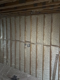 the ceiling of a house is being insulated with foam