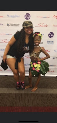 a woman and a girl posing for a photo at an event