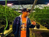 a man standing in a greenhouse