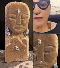 a photo of a woman wearing glasses and a stone sculpture