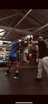 two men boxing in a gym