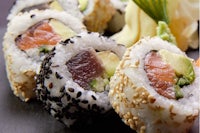 sushi with salmon, avocado and sesame seeds