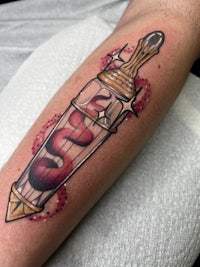 a tattoo of a bottle with lipstick on it