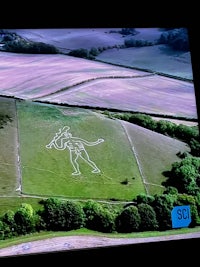 a tv screen showing a drawing of a man in a field