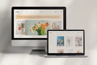 two monitors and a computer screen with a flower shop website