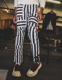 a man wearing black and white striped pants