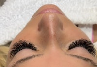 a woman with long lashes in a salon