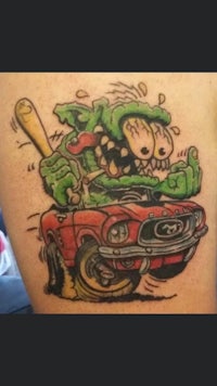 a tattoo of a zombie driving a car