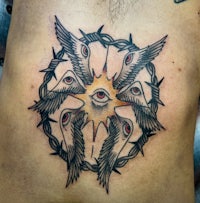 an all seeing eye tattoo on a man's chest