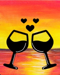 two wine glasses with hearts on them at sunset
