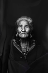 a black and white photo of an old woman