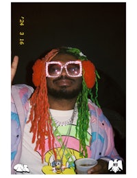 a man with colorful dreadlocks and sunglasses