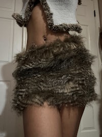 a woman posing in a furry skirt
