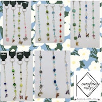 a variety of necklaces with beads and letters on them
