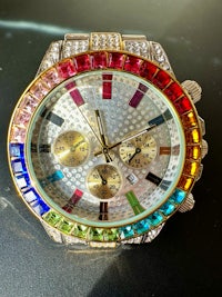 a rainbow colored watch on a table