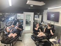 a group of people sitting in chairs in a salon