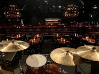 a drum set in a room with tables and chairs
