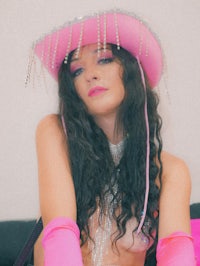 a woman wearing a pink cowboy hat