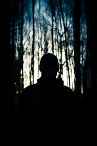 silhouette of a man in the woods