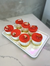 a tray of strawberry cheesecakes on a white plate