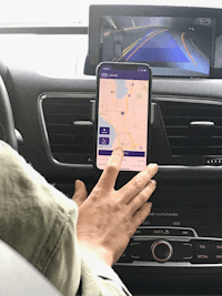 a person in a car using a smart phone to navigate