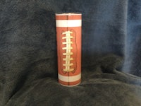 a cylinder with a football on it