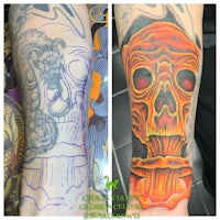 a tattoo of a skull and flames on a man's arm