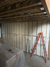a room with insulation being installed in the ceiling