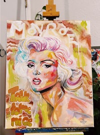 a painting of marilyn monroe on an easel