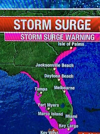 a tv screen showing a storm surge warning