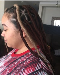 a woman with dreadlocks in her hair