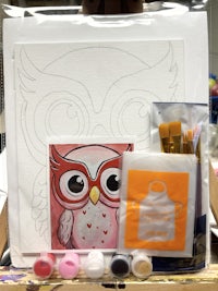 an owl painting kit with paints and brushes