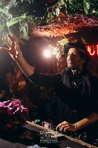 a man djing in front of a crowd of people