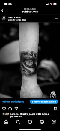a black and white photo of a tattoo on a person's arm