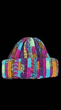 a colorful knitted hat on a black background