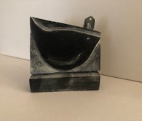 a sculpture of a bird sitting on top of a table
