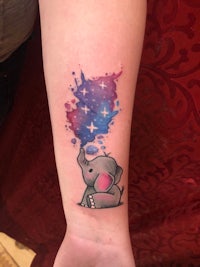 a tattoo of an elephant with stars on it