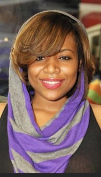 a woman wearing a purple scarf and a hoodie
