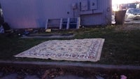 a rug on the ground in front of a building