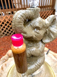 a statue of an elephant with a bottle on it