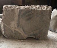 a piece of concrete sitting on top of a piece of wood
