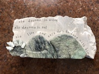 a piece of stone with a quote on it