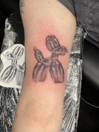 a tattoo of a balloon on a person's arm