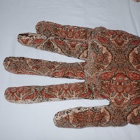 a stuffed hand with a paisley pattern on it