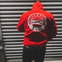 the back of a man wearing a red hoodie